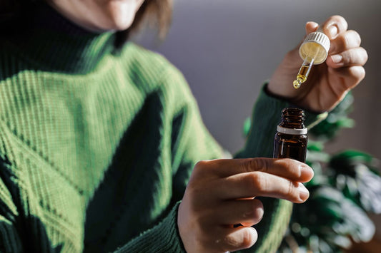 Woman holding an oil dropper