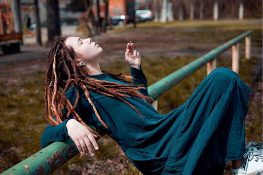 girl with dreadlocks hairstyle smoking