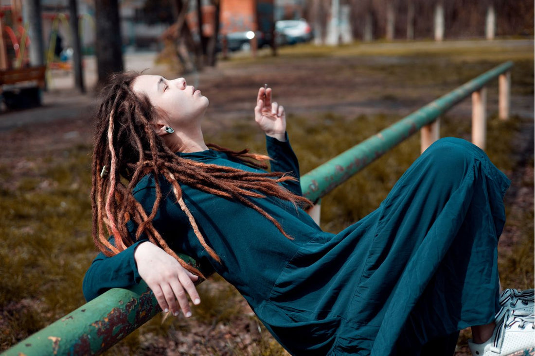 girl with dreadlocks hairstyle smoking